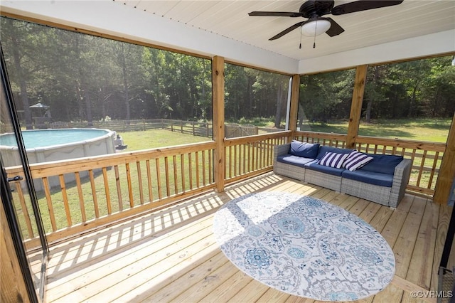 8851 Topeka Rd, Quinton, VA 23141 - deck featuring ceiling fan, a fenced backyard, an outdoor pool, an outdoor living space, and view of scattered trees