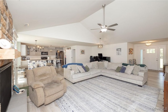 8851 Topeka Rd, Quinton, VA 23141 - living area featuring a chandelier, a ceiling fan, light wood-type flooring, a fireplace, and high vaulted ceiling