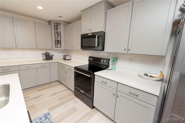 8851 Topeka Rd, Quinton, VA 23141 - kitchen featuring black appliances, gray cabinetry, tasteful backsplash, light wood-style floors, and recessed lighting