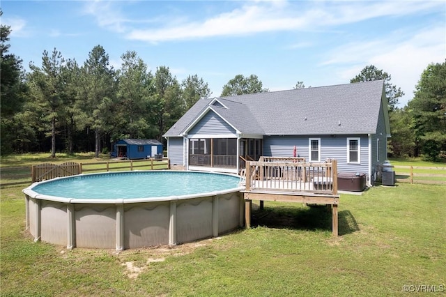 8851 Topeka Rd, Quinton, VA 23141 - back of property featuring a sunroom, a deck, a yard, a shingled roof, and an outdoor pool
