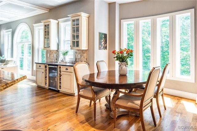 2631 Royal Crest Dr, Midlothian, VA 23113 - dining area with beverage cooler, healthy amount of natural light, light wood-style floors, and a bar