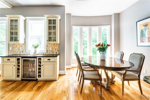 2631 Royal Crest Dr, Midlothian, VA 23113 - bar featuring beverage cooler, decorative backsplash, light wood-style flooring, and healthy amount of natural light