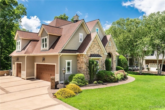 2631 Royal Crest Dr, Midlothian, VA 23113 - view of front of house with a front lawn, concrete driveway, a shingled roof, and stone siding