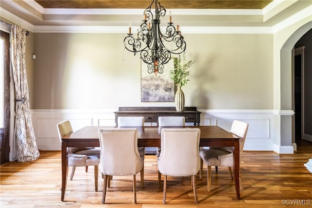 2631 Royal Crest Dr, Midlothian, VA 23113 - dining room featuring a chandelier, arched walkways, crown molding, wood finished floors, and wainscoting