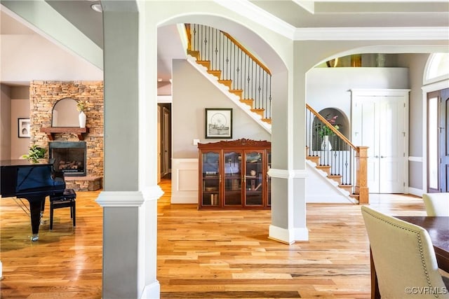 2631 Royal Crest Dr, Midlothian, VA 23113 - entryway featuring light wood-type flooring, stairway, a stone fireplace, crown molding, and a towering ceiling