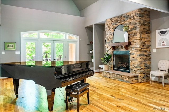 2631 Royal Crest Dr, Midlothian, VA 23113 - living area featuring wood finished floors, high vaulted ceiling, a fireplace, and french doors