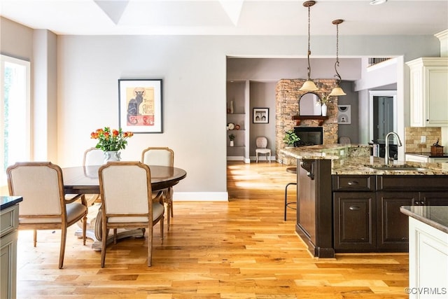 2631 Royal Crest Dr, Midlothian, VA 23113 - dining area featuring light wood-style floors and a stone fireplace