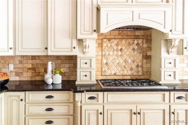 2631 Royal Crest Dr, Midlothian, VA 23113 - kitchen featuring stainless steel gas cooktop, cream cabinetry, premium range hood, and decorative backsplash