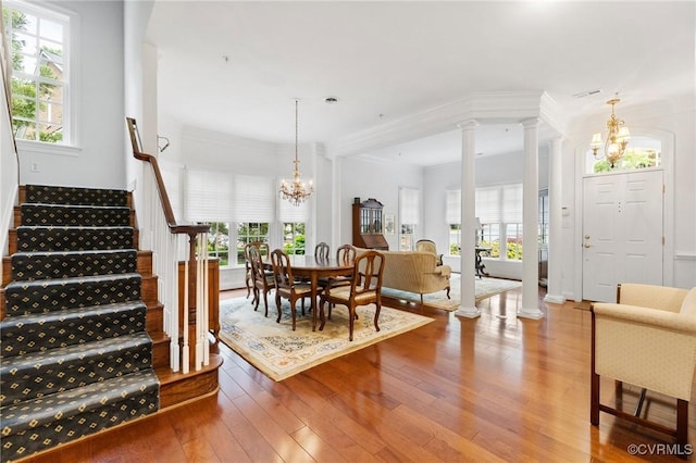 9522 Nassington Ct, Henrico, VA 23229 - dining area with a chandelier, decorative columns, hardwood / wood-style flooring, stairs, and crown molding