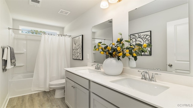7007 Greenholm Pl, Chesterfield, VA 23234 - bathroom featuring wood finished floors, double vanity, and shower / tub combo