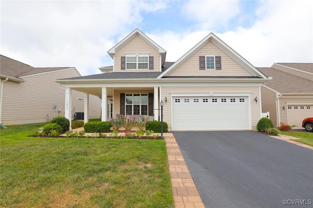 7822 James Blair Ln, New Kent, VA 23124 - traditional-style home with asphalt driveway, a front lawn, a porch, and a garage