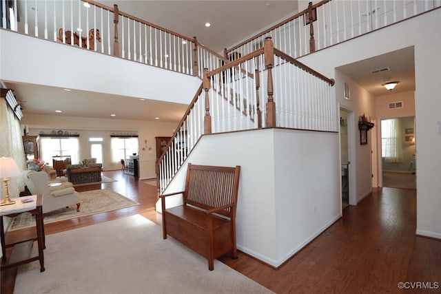 7822 James Blair Ln, New Kent, VA 23124 - staircase featuring a towering ceiling, wood finished floors, and recessed lighting
