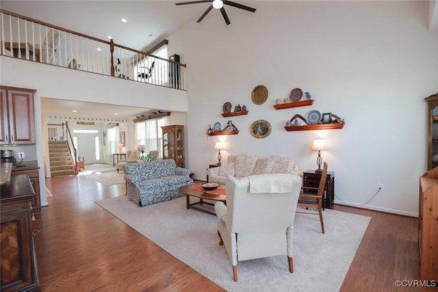 7822 James Blair Ln, New Kent, VA 23124 - living room with ceiling fan, stairway, wood finished floors, and high vaulted ceiling