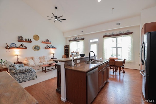 7822 James Blair Ln, New Kent, VA 23124 - kitchen featuring stainless steel dishwasher, freestanding refrigerator, open floor plan, wood finished floors, and a ceiling fan