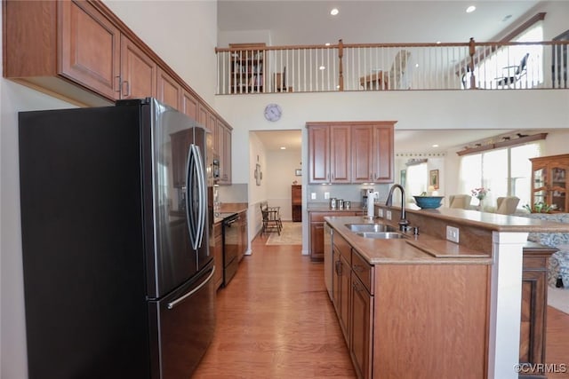 7822 James Blair Ln, New Kent, VA 23124 - kitchen with freestanding refrigerator, light wood finished floors, healthy amount of natural light, range with electric stovetop, and a high ceiling