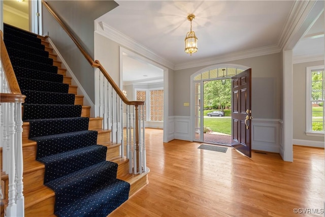 2619 Mulberry Row Rd, Midlothian, VA 23113 - entryway featuring stairs, a chandelier, light wood finished floors, ornamental molding, and wainscoting