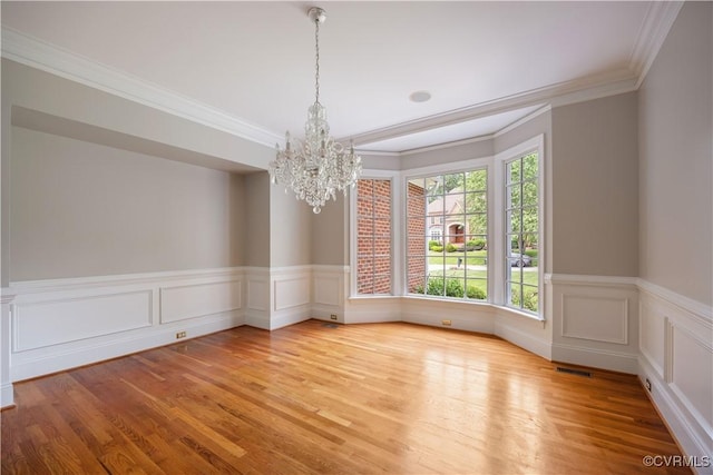 2619 Mulberry Row Rd, Midlothian, VA 23113 - empty room featuring a chandelier, ornamental molding, light wood-type flooring, and wainscoting