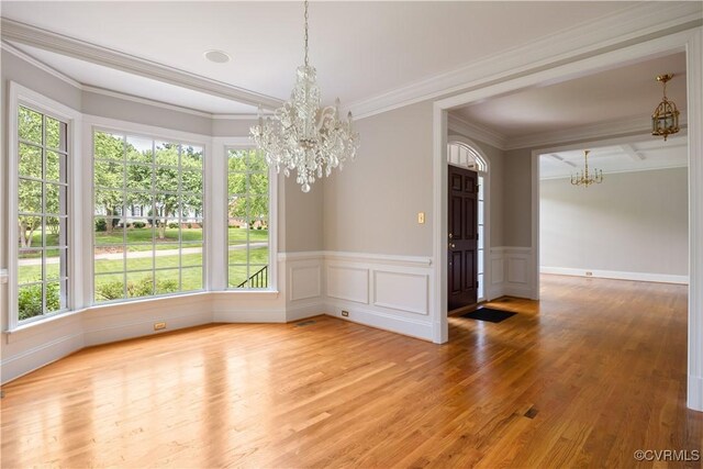2619 Mulberry Row Rd, Midlothian, VA 23113 - empty room with a chandelier, wood finished floors, crown molding, and wainscoting