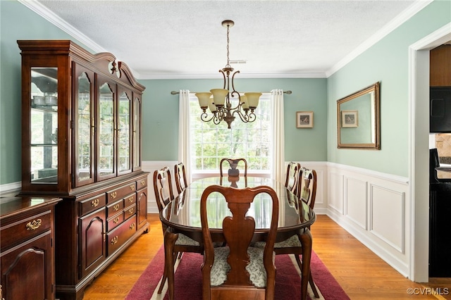 1917 Moonwind Pl, Henrico, VA 23238 - dining room with a chandelier, ornamental molding, light wood-type flooring, a wainscoted wall, and a textured ceiling