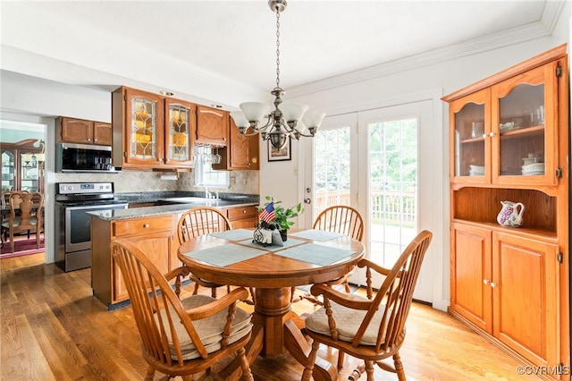 1917 Moonwind Pl, Henrico, VA 23238 - dining area with a chandelier, light wood-style floors, and crown molding