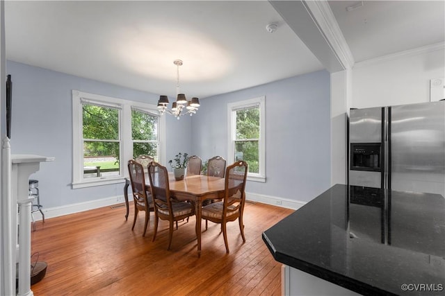 104 E 5th St, Mineral, VA 23117 - dining space with a chandelier, light wood finished floors, and crown molding