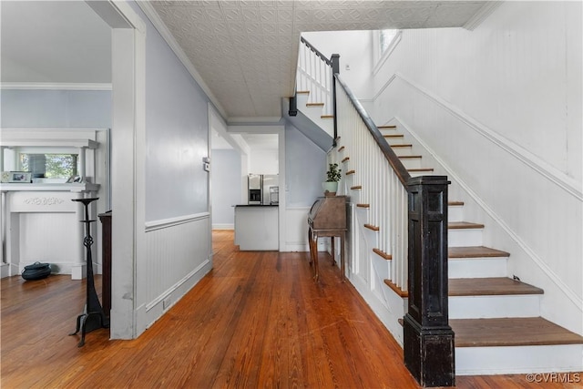 104 E 5th St, Mineral, VA 23117 - staircase featuring wood finished floors, ornamental molding, and a decorative wall