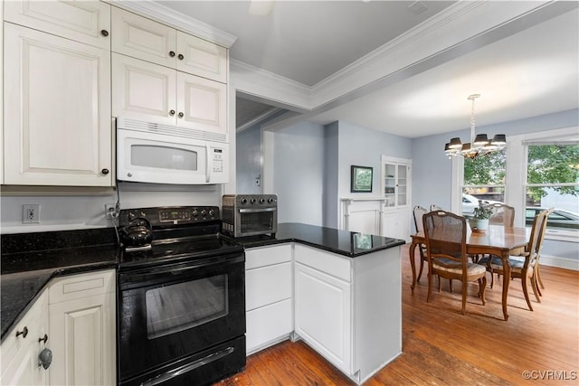104 E 5th St, Mineral, VA 23117 - kitchen featuring white microwave, black range with electric stovetop, wood finished floors, crown molding, and a peninsula