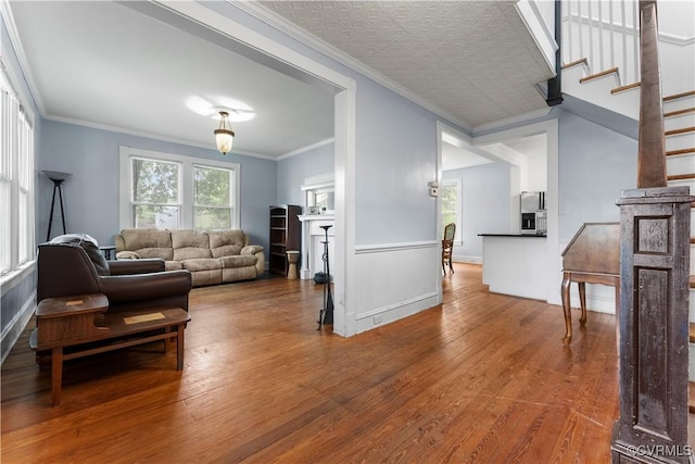 104 E 5th St, Mineral, VA 23117 - living room featuring wood finished floors, a wainscoted wall, crown molding, and stairway