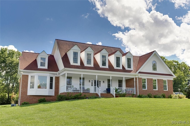 2104 Apple Grove Rd, Mineral, VA 23117 - cape cod-style house with covered porch, a front yard, and brick siding