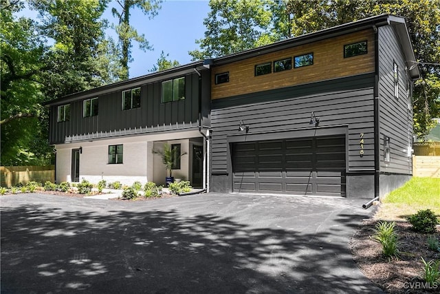7418 Cherokee Rd, Richmond, VA 23225 - view of front facade featuring asphalt driveway, board and batten siding, and an attached garage