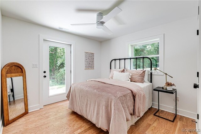 7418 Cherokee Rd, Richmond, VA 23225 - bedroom featuring access to exterior, multiple windows, light wood-style flooring, and a ceiling fan