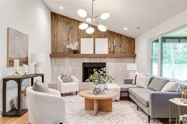 7418 Cherokee Rd, Richmond, VA 23225 - living area with high vaulted ceiling, a chandelier, light wood-style floors, and a fireplace