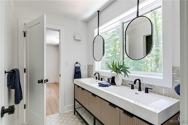 7418 Cherokee Rd, Richmond, VA 23225 - full bath with plenty of natural light, double vanity, tasteful backsplash, and wood finished floors