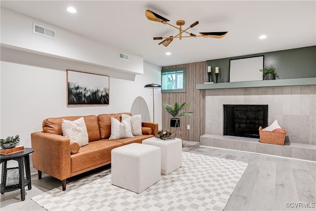 7418 Cherokee Rd, Richmond, VA 23225 - living room featuring wood finished floors, recessed lighting, and a tile fireplace