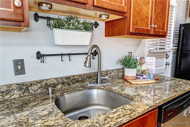 2710 Stuart Ave Unit U3, Richmond, VA 23220 - kitchen with stainless steel dishwasher, light stone counters, brown cabinetry, and freestanding refrigerator