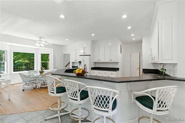 4800 Bailey Branch Ln, Quinton, VA 23141 - kitchen featuring fridge with ice dispenser, white cabinetry, recessed lighting, light tile patterned floors, and ceiling fan