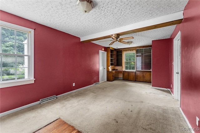 200 Hargrave Ave, Colonial Heights, VA 23834 - empty room with healthy amount of natural light, a textured ceiling, carpet, ceiling fan, and beam ceiling