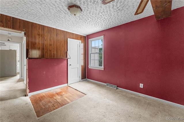 200 Hargrave Ave, Colonial Heights, VA 23834 - empty room with carpet floors, ceiling fan, and wooden walls
