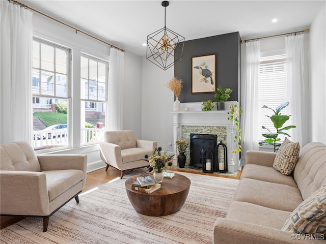 130 N Jefferson St, Petersburg, VA 23803 - living area with wood finished floors, a chandelier, a fireplace with flush hearth, and recessed lighting