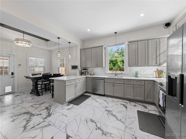 130 N Jefferson St, Petersburg, VA 23803 - kitchen featuring gray cabinetry, appliances with stainless steel finishes, a peninsula, tasteful backsplash, and plenty of natural light
