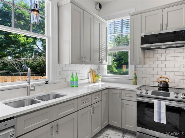 130 N Jefferson St, Petersburg, VA 23803 - kitchen with stainless steel appliances, light marble finish floors, light countertops, and decorative backsplash