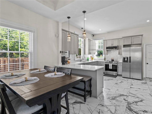 130 N Jefferson St, Petersburg, VA 23803 - kitchen featuring appliances with stainless steel finishes, gray cabinets, a peninsula, tasteful backsplash, and light marble finish flooring