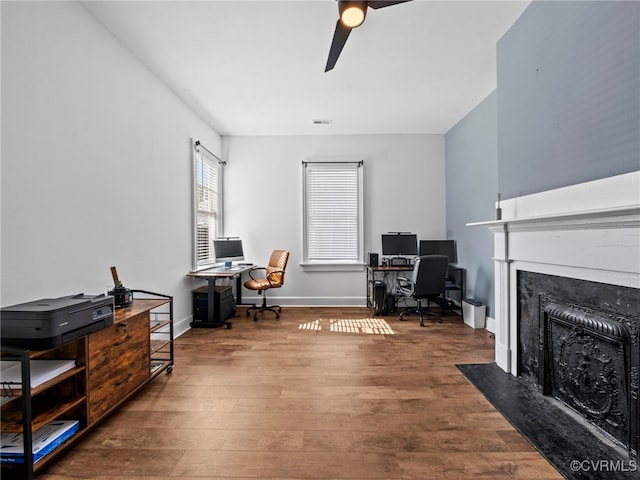 130 N Jefferson St, Petersburg, VA 23803 - home office featuring a ceiling fan, wood finished floors, and a fireplace with flush hearth