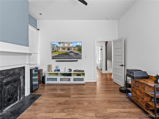 130 N Jefferson St, Petersburg, VA 23803 - living room with a fireplace, wood finished floors, beverage cooler, and ceiling fan