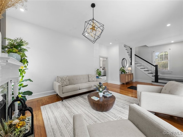 130 N Jefferson St, Petersburg, VA 23803 - living room featuring stairway, recessed lighting, wood finished floors, a high end fireplace, and a chandelier