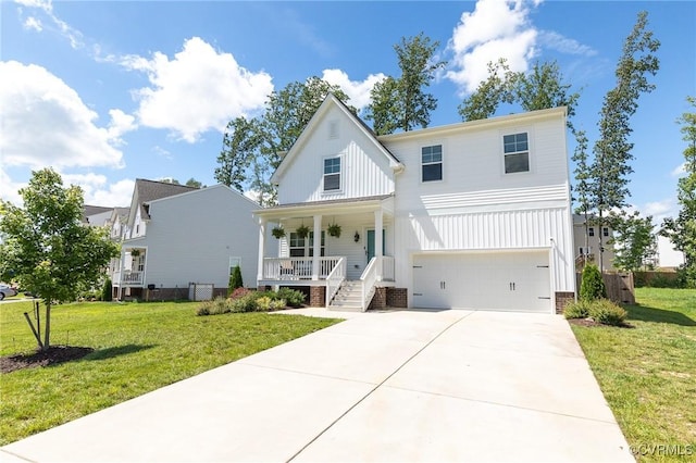 236 Central Pkwy, Aylett, VA 23009 - view of front of home with covered porch, board and batten siding, a garage, and a front yard