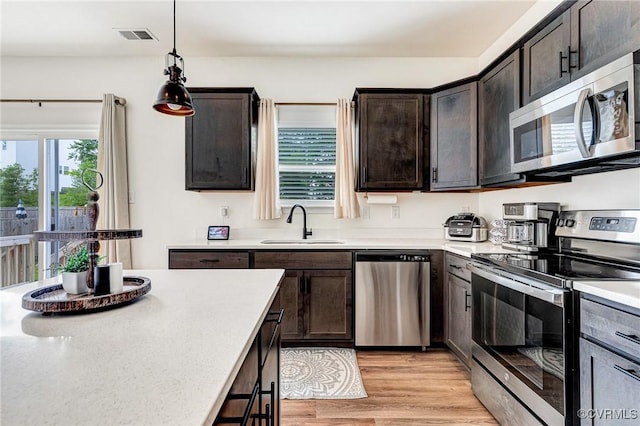 236 Central Pkwy, Aylett, VA 23009 - kitchen featuring stainless steel appliances, light countertops, dark brown cabinetry, and light wood-style floors