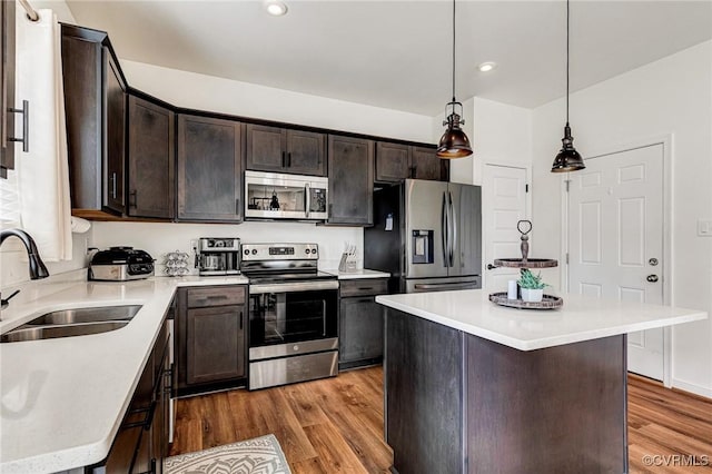 236 Central Pkwy, Aylett, VA 23009 - kitchen featuring stainless steel appliances, light wood-style floors, dark brown cabinets, light countertops, and decorative light fixtures
