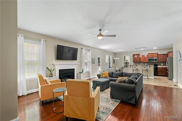 8307 Badestowe Ct, Chesterfield, VA 23832 - living area with a ceiling fan, wood-type flooring, and a glass covered fireplace