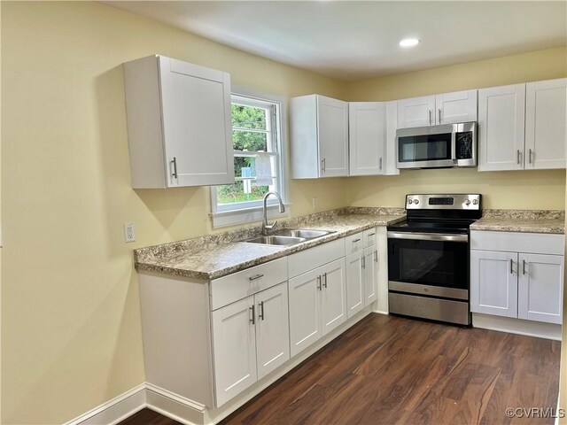 318 Youngs Rd, Petersburg, VA 23803 - kitchen featuring appliances with stainless steel finishes, white cabinetry, dark wood finished floors, light countertops, and recessed lighting